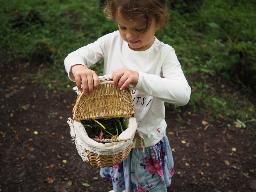 Girl collecting nature in basket